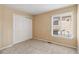 Neutral bedroom with a closet, carpeted floor, and window providing natural light at 6743 Serena Ave, Castle Pines, CO 80108