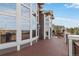 Inviting outdoor deck featuring a stained wood floor and a wall of windows at 6743 Serena Ave, Castle Pines, CO 80108