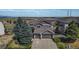 Aerial view of home with a three-car garage, landscaping and mountain views at 6743 Serena Ave, Castle Pines, CO 80108
