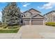Two-story home featuring a three car garage, dark siding, and manicured landscaping at 6743 Serena Ave, Castle Pines, CO 80108
