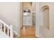 Grand foyer with soaring ceilings, hardwood floors, a staircase, and arched entryway at 6743 Serena Ave, Castle Pines, CO 80108