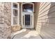 Inviting front entrance showcasing a black front door, sidelights, and transom window at 6743 Serena Ave, Castle Pines, CO 80108
