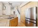 Spacious kitchen featuring stainless steel refrigerator and convenient breakfast bar at 6743 Serena Ave, Castle Pines, CO 80108