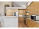 Bright kitchen with light wood cabinets, stainless steel appliances, and functional layout at 6743 Serena Ave, Castle Pines, CO 80108