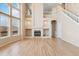 Open living room with fireplace, built-in shelving, and large windows offering ample natural light at 6743 Serena Ave, Castle Pines, CO 80108
