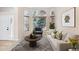 Cozy living room with a comfortable sofa, accent chair, and decorative rug at 6743 Serena Ave, Castle Pines, CO 80108