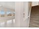 Bright open living space with light hardwood floors and stairs nearby at 6743 Serena Ave, Castle Pines, CO 80108