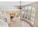 Bright, open-concept living area with large windows and an adjacent kitchen at 6743 Serena Ave, Castle Pines, CO 80108