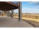 Covered patio with stone accents, offering views of the backyard and beyond at 6743 Serena Ave, Castle Pines, CO 80108