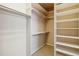 Organized walk-in closet with multiple shelves and hanging rods for ample storage at 6743 Serena Ave, Castle Pines, CO 80108