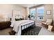 Bright bedroom with large windows, neutral colors, stylish furnishings, and comfortable bedding at 20 Wilcox St # 410, Castle Rock, CO 80104