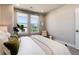 Comfortable bedroom with soft lighting, plush bedding, and a view of the neighborhood from large windows at 20 Wilcox St # 410, Castle Rock, CO 80104