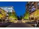 Night shot of common area with plants, benches and outdoor seating between buildings at 20 Wilcox St # 410, Castle Rock, CO 80104