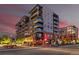 Modern condo building with balconies, street-level retail, and well-lit sidewalks for evening strolls at 20 Wilcox St # 410, Castle Rock, CO 80104
