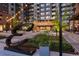 Well-lit exterior view of the Encore building entrance with a modern sculpture and inviting landscaping at 20 Wilcox St # 410, Castle Rock, CO 80104