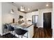 A modern kitchen with stainless steel appliances, white cabinets, breakfast bar and dark hardwood floors at 20 Wilcox St # 410, Castle Rock, CO 80104
