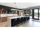 Modern kitchen features an island with seating, sleek countertops, and access to an outdoor patio at 20 Wilcox St # 410, Castle Rock, CO 80104