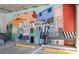 EV charging station area in the parking garage featuring a large mural and parking spots at 20 Wilcox St # 410, Castle Rock, CO 80104