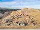 Scenic aerial view of the property featuring homes nestled among the landscape with a water feature at 208 Wark Ave, Berthoud, CO 80513