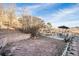Spacious backyard featuring a patio area, swing set, and fire pit, perfect for outdoor activities at 208 Wark Ave, Berthoud, CO 80513
