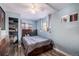 Light blue bedroom with a ceiling fan, wood-look floors, and built in shelving at 208 Wark Ave, Berthoud, CO 80513