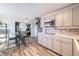 Open-concept kitchen with stainless steel appliances, granite countertops, gray cabinets, and tile backsplash at 208 Wark Ave, Berthoud, CO 80513
