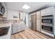 Modern kitchen with stainless steel appliances, double ovens, gray cabinetry, and wood-look flooring at 208 Wark Ave, Berthoud, CO 80513