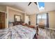 Bright main bedroom with a vaulted ceiling, wood floors, and large window providing natural light and scenic views at 208 Wark Ave, Berthoud, CO 80513