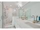 Spa-like bathroom with a walk-in shower, double vanity, and marble tile at 2945 S Elati St, Englewood, CO 80110