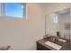 Modern bathroom with dual sinks, large mirror, and a window at 2945 S Elati St, Englewood, CO 80110