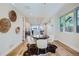 Light-filled dining area with hardwood floors and a cowhide rug at 2945 S Elati St, Englewood, CO 80110