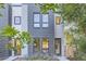 Contemporary townhome with a gray brick facade and wood fence at 2945 S Elati St, Englewood, CO 80110