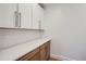 Clean, modern kitchen with white cabinets and wood lower cabinets at 2945 S Elati St, Englewood, CO 80110