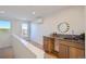 Stylish wet bar with wood cabinets, a sink, and a view to a balcony at 2945 S Elati St, Englewood, CO 80110