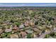 An aerial view shows this property nestled in a neighborhood with mature trees and nearby community spaces at 433 S Vaughn Way, Aurora, CO 80012