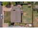 This aerial view shows the roof, well maintained lawn and surrounding neighborhood at 433 S Vaughn Way, Aurora, CO 80012