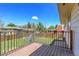 Back deck with wood decking, black metal railing, and view of the backyard at 433 S Vaughn Way, Aurora, CO 80012