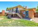 Exterior featuring a well maintained lawn, upper deck with stairs, and brick accents at 433 S Vaughn Way, Aurora, CO 80012