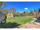 Spacious backyard featuring a shed, privacy fence, lush lawn, and access to a deck at 433 S Vaughn Way, Aurora, CO 80012