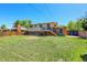 A level backyard boasts a spacious lawn, sturdy fence, and convenient access to an upper deck at 433 S Vaughn Way, Aurora, CO 80012
