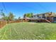 Well-maintained backyard features a lush lawn, wooden fence, and access to a deck at 433 S Vaughn Way, Aurora, CO 80012