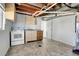 Unfinished basement with stove, sink, and access door, ready for customization at 433 S Vaughn Way, Aurora, CO 80012