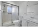 Bathroom featuring tiled floors, shower with glass doors, and sink with vanity at 433 S Vaughn Way, Aurora, CO 80012