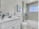 Bathroom featuring tiled shower, white vanity, and bright natural lighting at 433 S Vaughn Way, Aurora, CO 80012