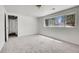 Bedroom featuring neutral carpet, large window, and ample natural light at 433 S Vaughn Way, Aurora, CO 80012