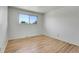 Bright bedroom features hardwood floors, a large window, and ample natural light at 433 S Vaughn Way, Aurora, CO 80012
