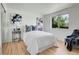Inviting bedroom with hardwood floors, white walls, and large window with natural light at 433 S Vaughn Way, Aurora, CO 80012