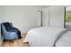 Cozy bedroom features hardwood floors, a chair, and large window for natural light at 433 S Vaughn Way, Aurora, CO 80012