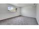 Spacious bedroom featuring neutral carpet, large window, and ample natural light at 433 S Vaughn Way, Aurora, CO 80012