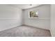 Bedroom with neutral carpet, window providing natural light, and white walls at 433 S Vaughn Way, Aurora, CO 80012